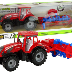 Traktor s třecím pohonem a pluhem červený