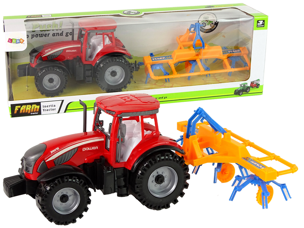 Traktor s třecím pohonem a se shrnovačem sena červený